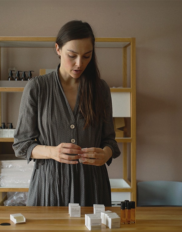 A woman looking at small boxes.