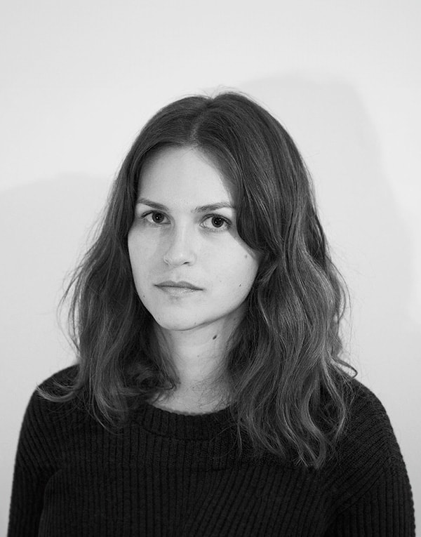 A black and white photo of a woman with long hair.