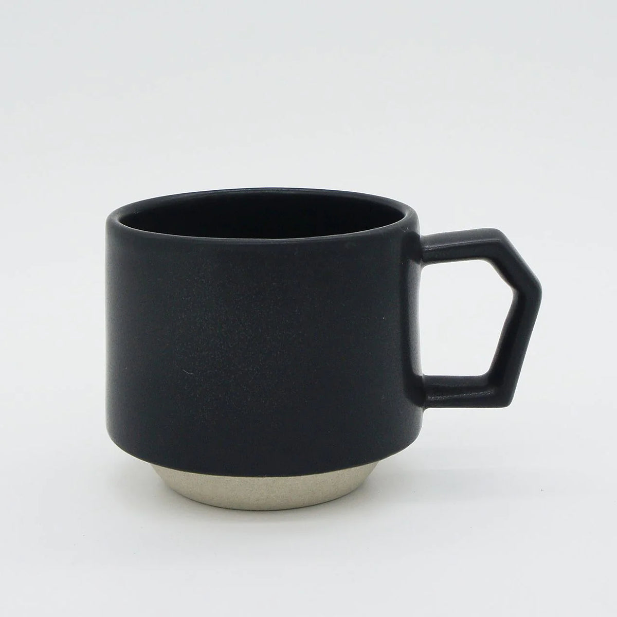 A CHIPS Inc. Stacking Mug - Black with a handle.