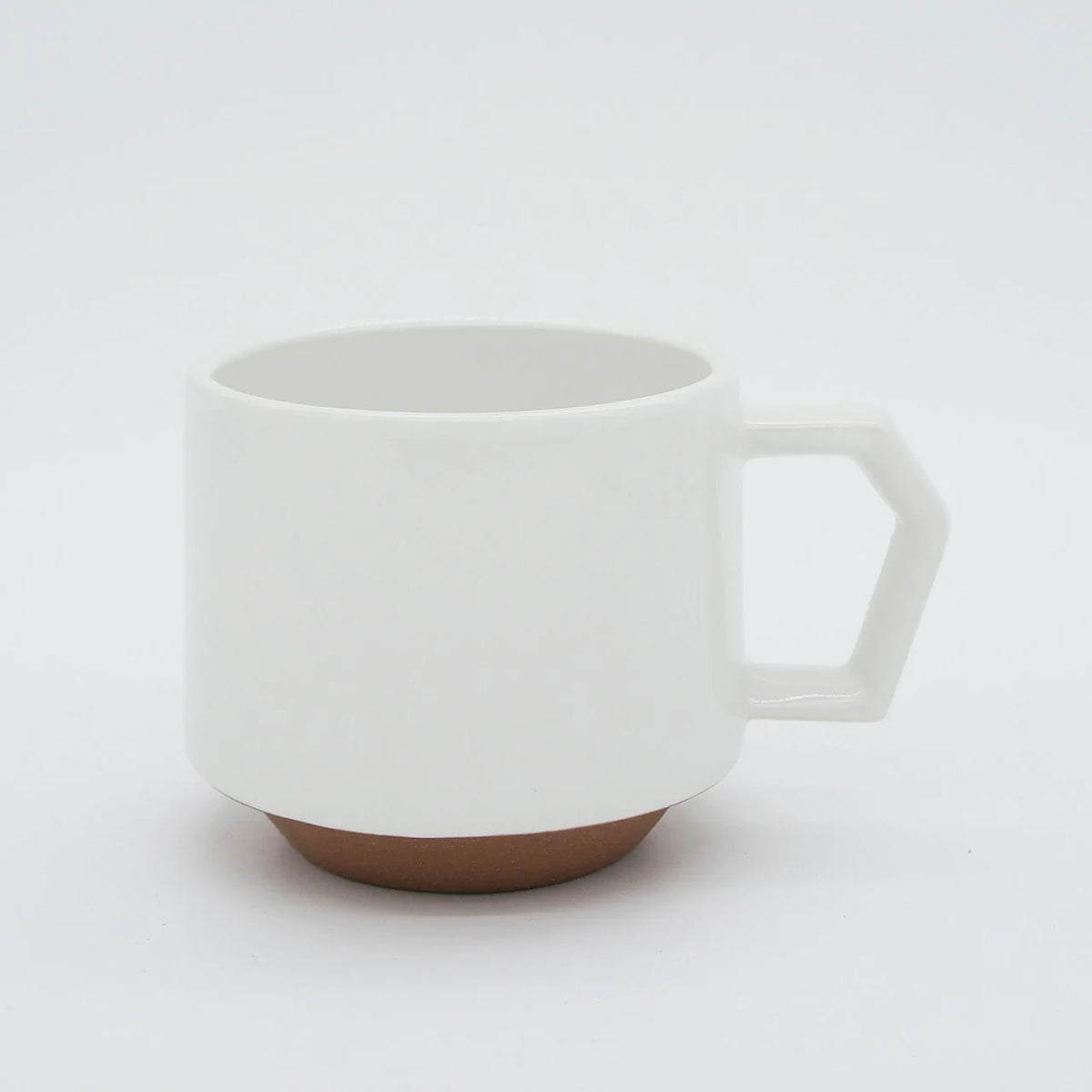 A Stacking Mug – White with a brown handle on a white background, combining functionality and aesthetic appeal. - CHIPS Inc.