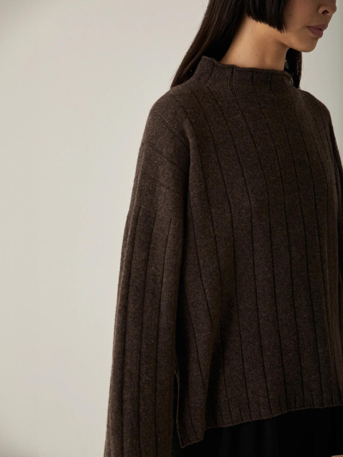 The model is wearing an oversized brown sweater made from 100% Merino Wool by Francie&#39;s Echo Knit in Truffle.