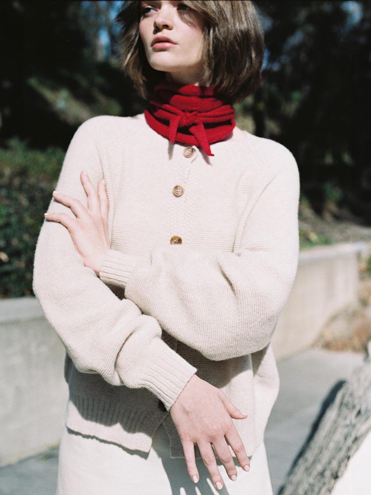 A woman with an oversized Francie Loft Cardigan – Creme around her neck.