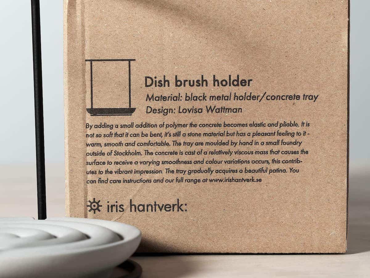 A close up of an Iris Hantverk dish brush holder box with product description.
