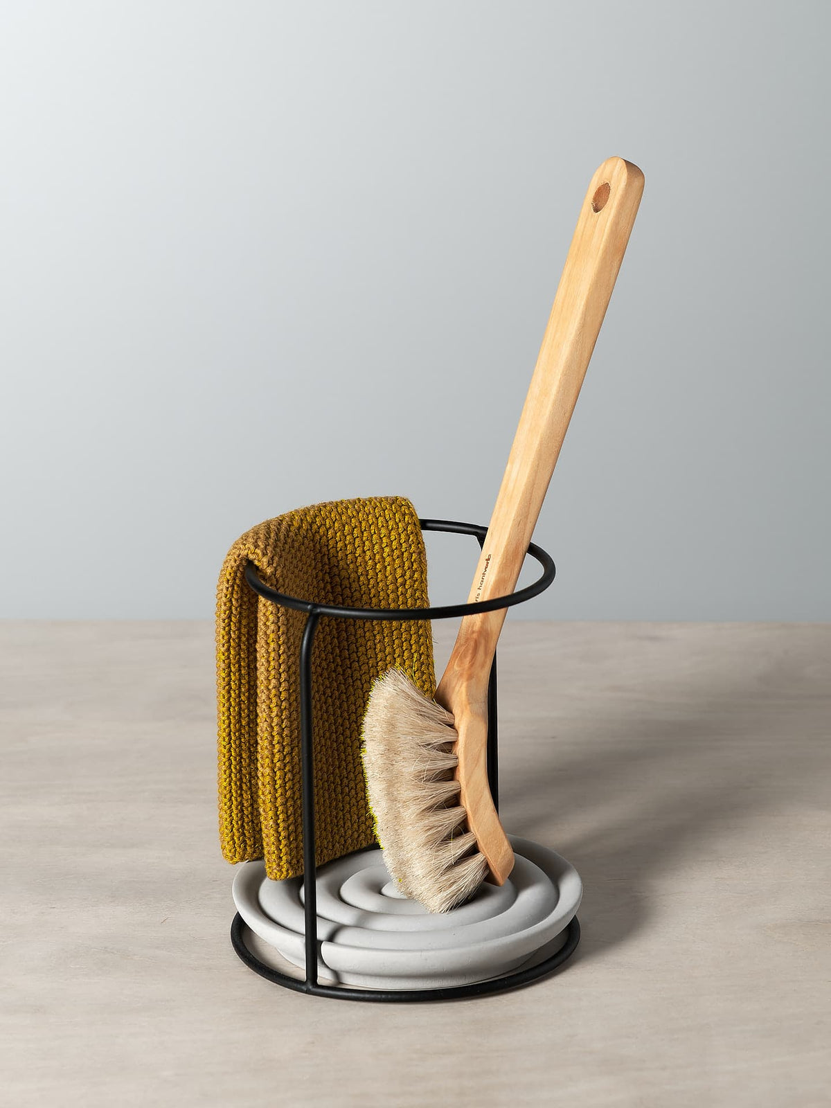 A Dish Brush Holder with a mustard colour cloth and wooden brush, all by Iris Hantverk.