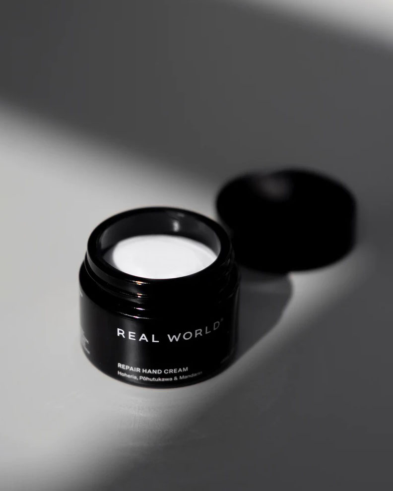 A jar of Repair Hand Cream – Hoheria, Pōhutukawa & Mandarin by Real World on a table.