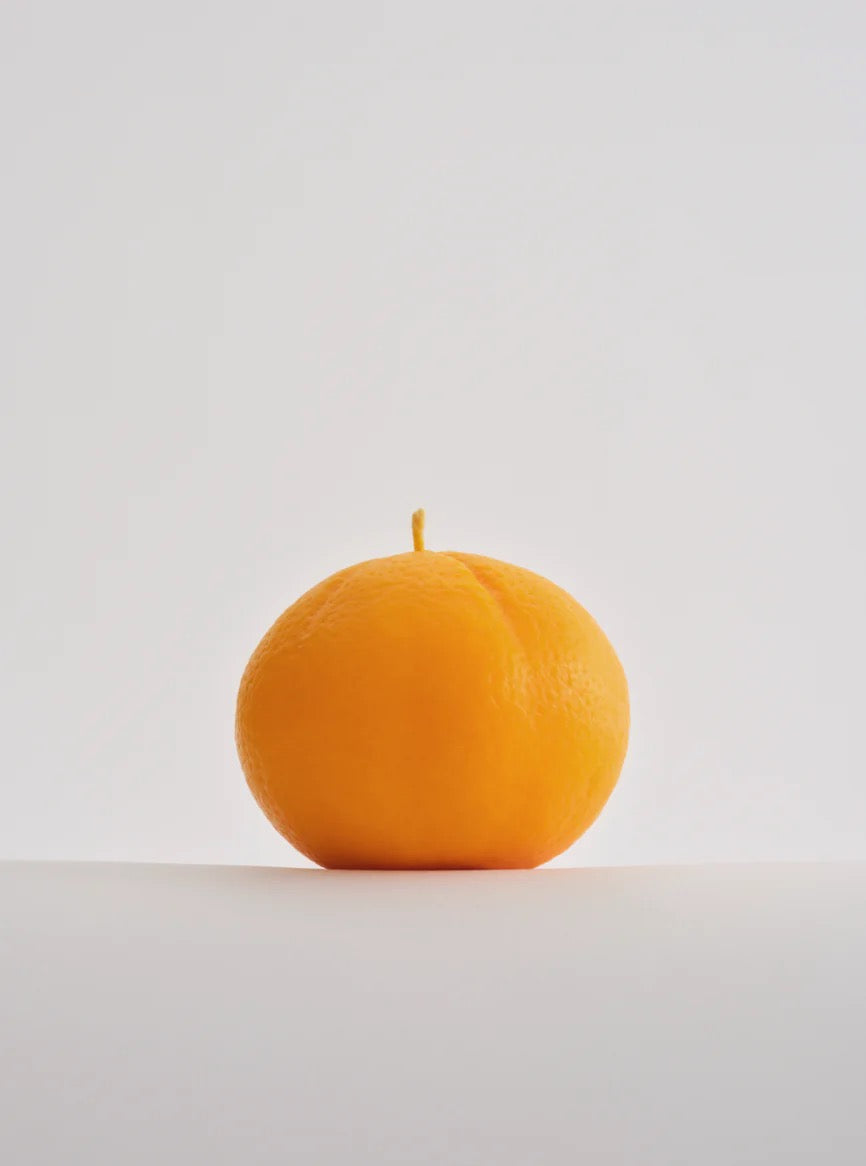 A hand-made Nonna&#39;s Grocer Mandarin Candle – Large, made with a soy wax blend, sitting on a white surface.