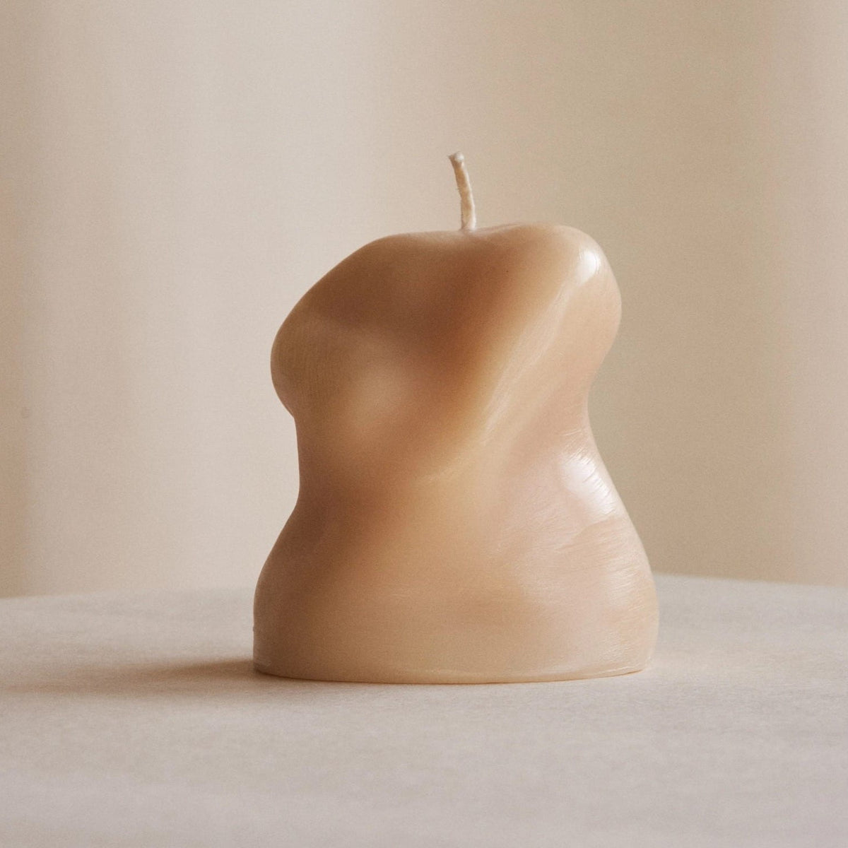 A Sole Set candle with a woman&#39;s body on it by ann vincent.