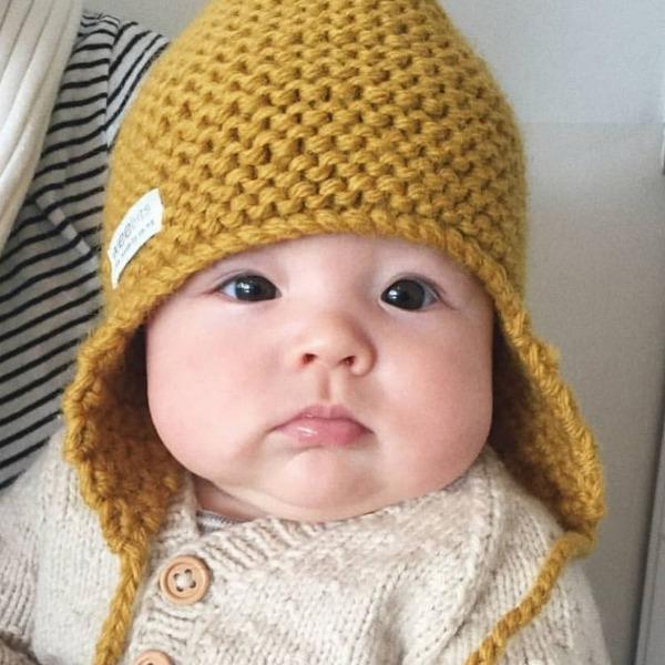 A baby wearing a yellow Hand Knitted Chunky Knit Hat - Mustard by Weebits.