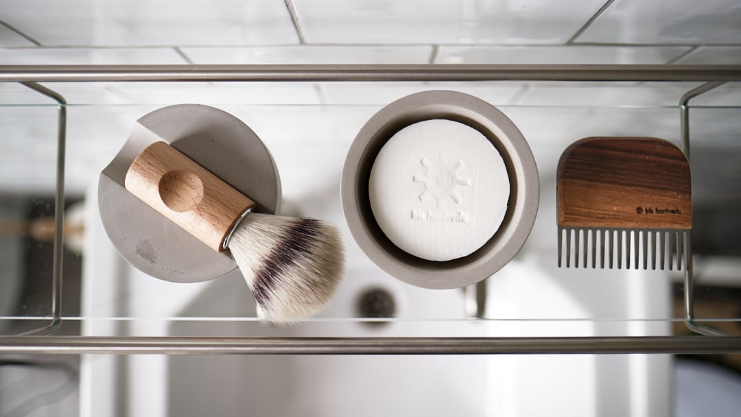 A bathroom with a Shaving Brush &amp; Cup with Cedarwood Soap by Iris Hantverk.