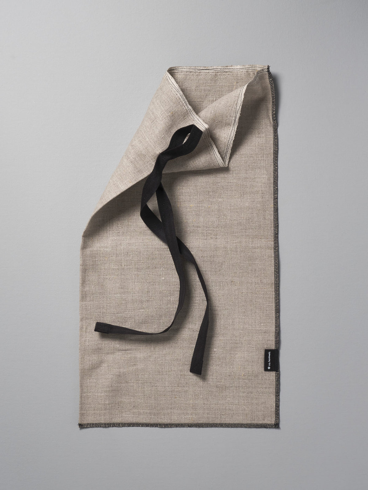 A Bread Bag - Linen towel with a black ribbon on it by Iris Hantverk.