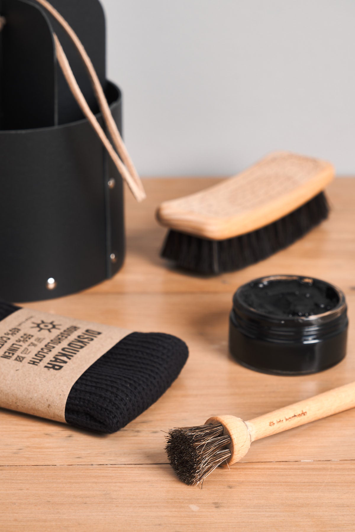 An Iris Hantverk Shoe Care Kit with a brush, brush, and other items.