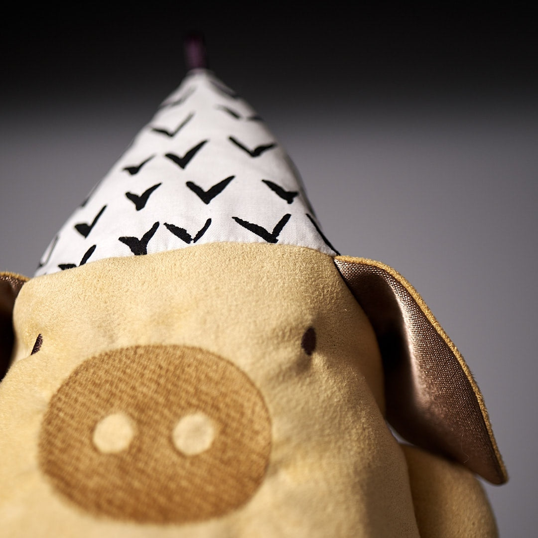 A Yali le Cochon stuffed pig wearing a party hat by Raplapla.