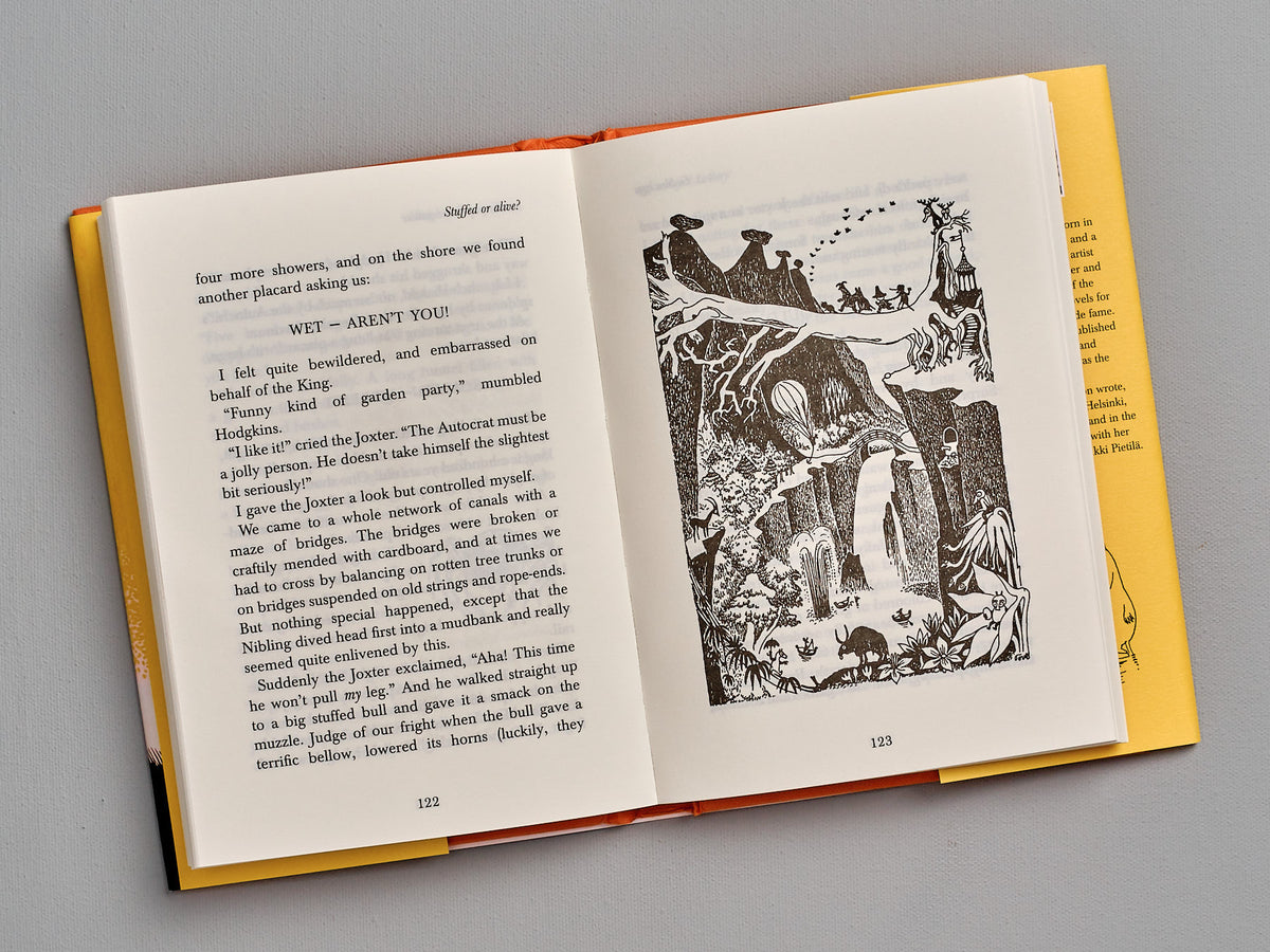 An open book with an illustration of &quot;The Memoirs of Moominpappa&quot; by Tove Jansson.