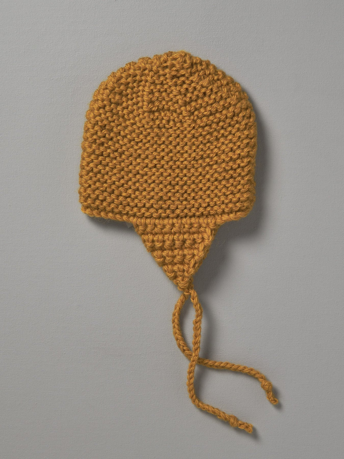 A yellow Hand Knitted Chunky Knit Hat - Mustard by Weebits on a white background.