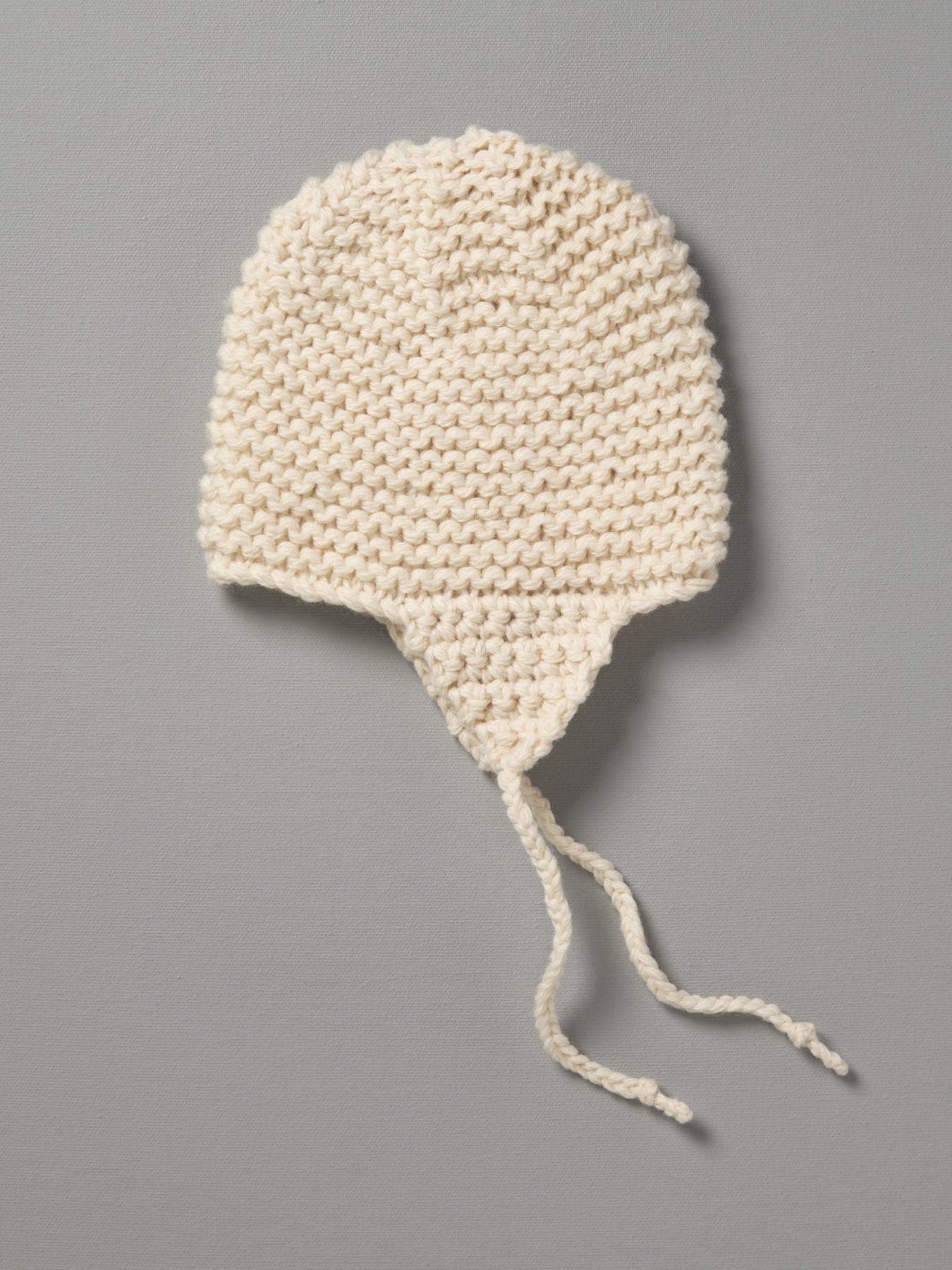A Hand Knitted Chunky Knit Hat - Natural from Weebits on a gray background.