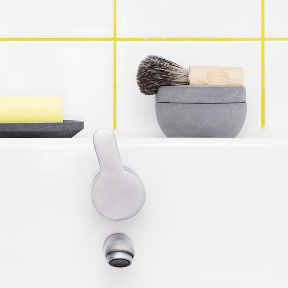 A yellow and white bathroom with a Shaving Brush &amp; Cup from Iris Hantverk and Cedarwood Soap.