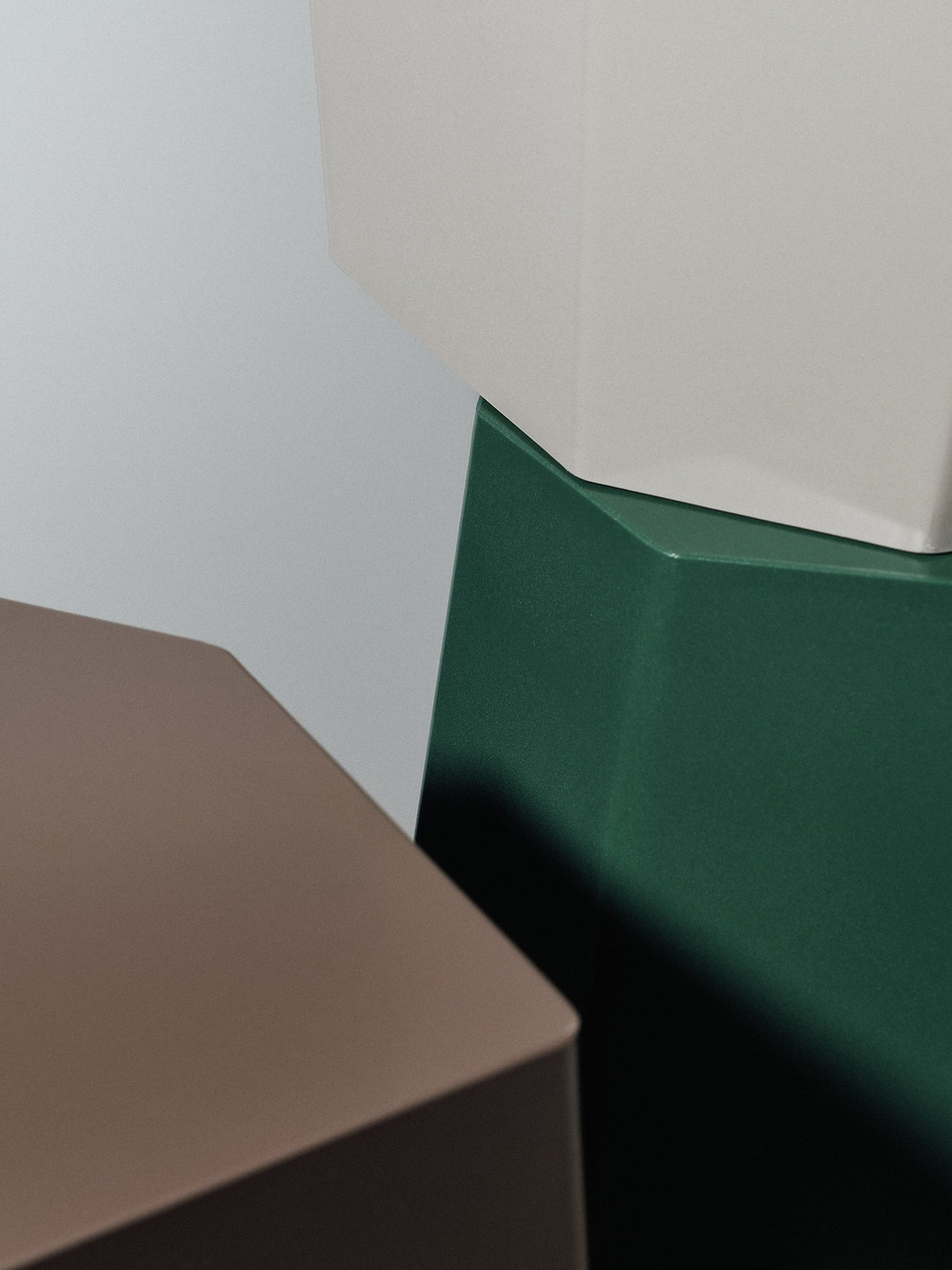 A green, brown, and beige set of Arnold Circus Stool – Cocoa side tables by Martino Gamper.