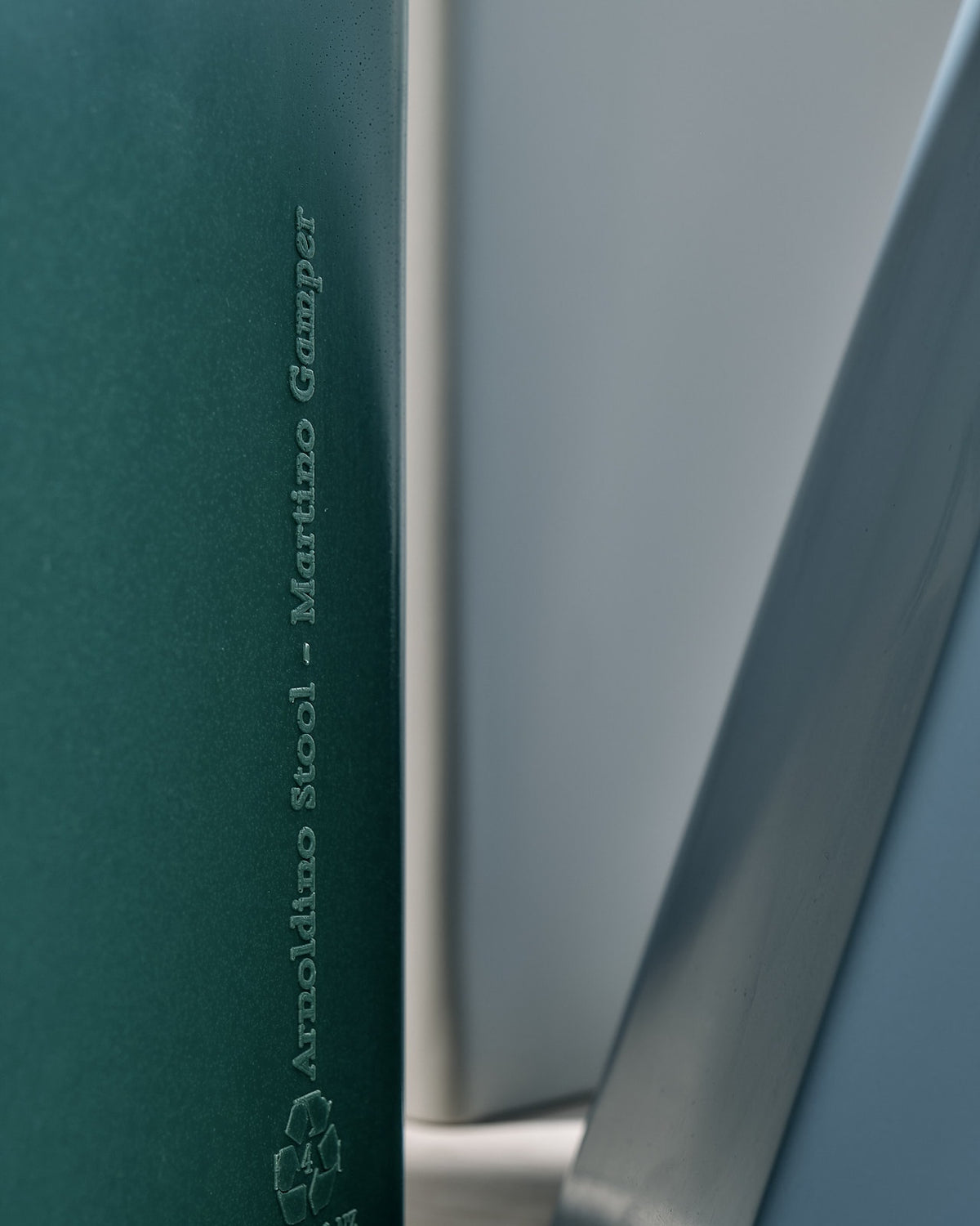 A blue and green Arnold Circus Stool - Forest by Martino Gamper is sitting on a table.