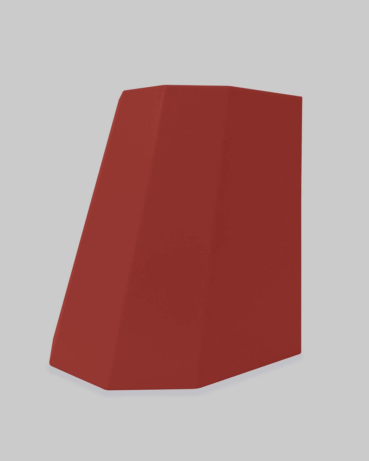 Against a light gray background, the Martino Gamper Arnold Circus Stool in Heritage Red showcases its angular, geometric design with a slanted top, crafted from recyclable polyethylene plastic.