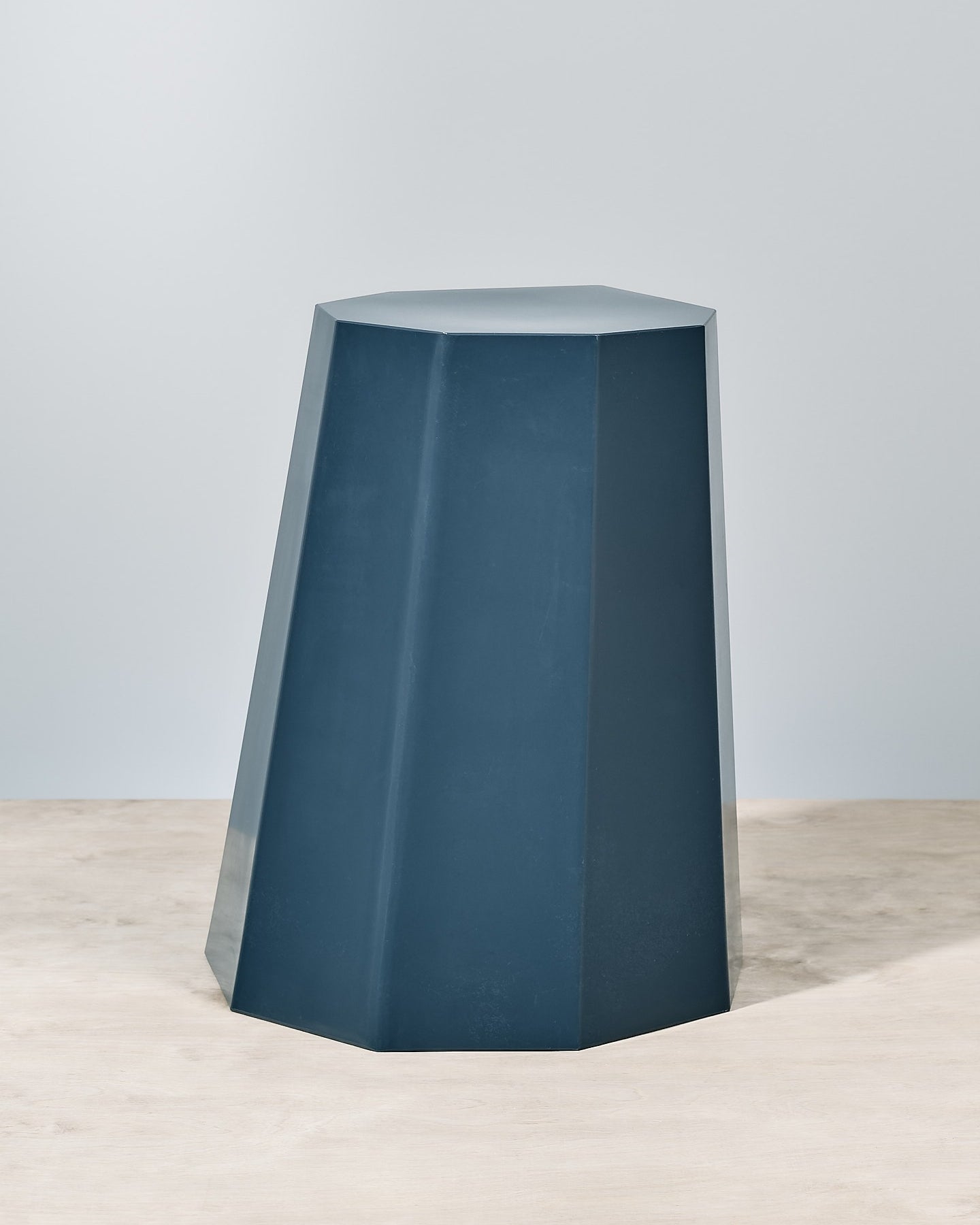 A Martino Gamper Arnold Circus Stool - Navy on a wooden floor.