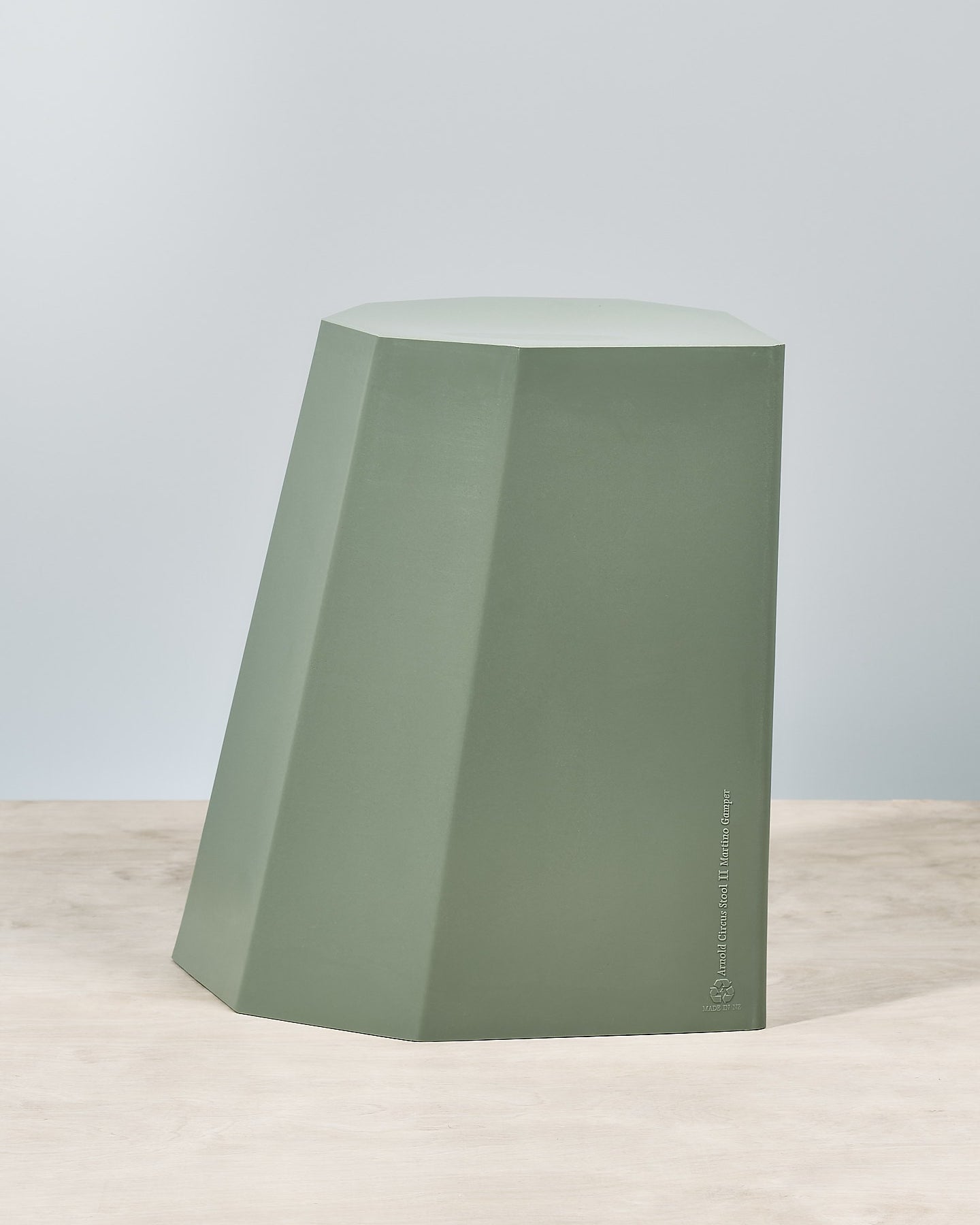 An Arnold Circus Stool - Sage by Martino Gamper on top of a table.