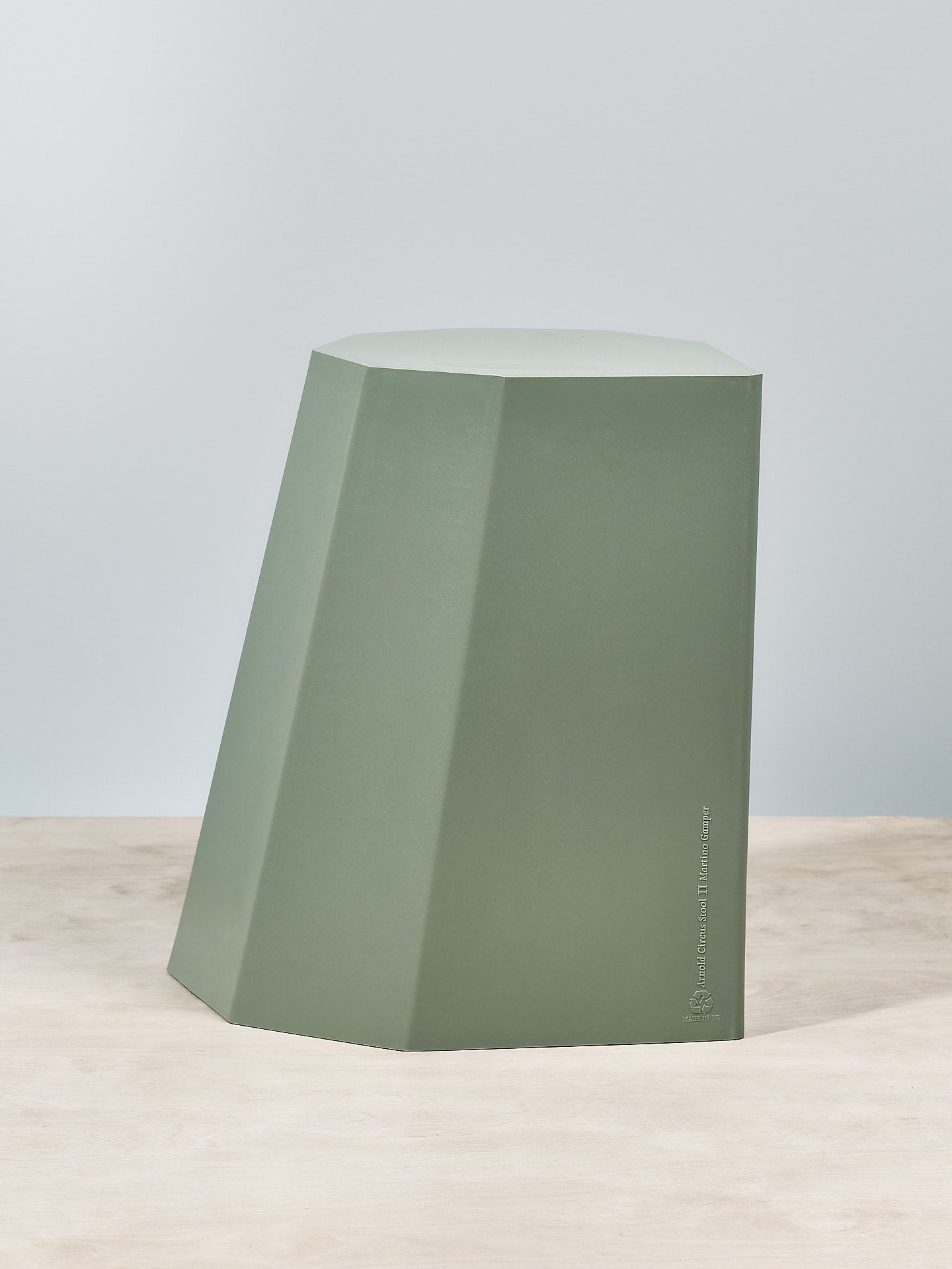 An Arnold Circus Stool - Sage by Martino Gamper on top of a table.