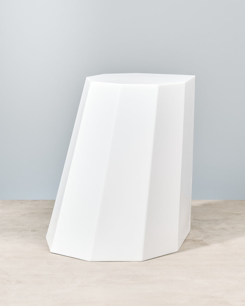 An Arnold Circus Stool - Chalk by Martino Gamper sitting on top of a wooden table.