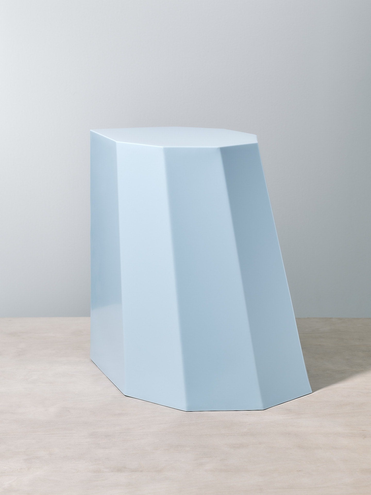 A Martino Gamper Baby Blue Arnold Circus Stool on top of a white table.