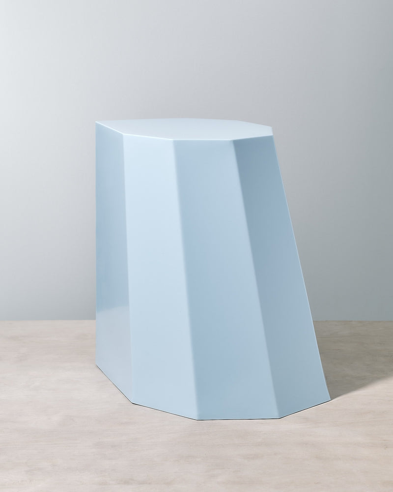 A Martino Gamper Baby Blue Arnold Circus Stool on top of a white table.