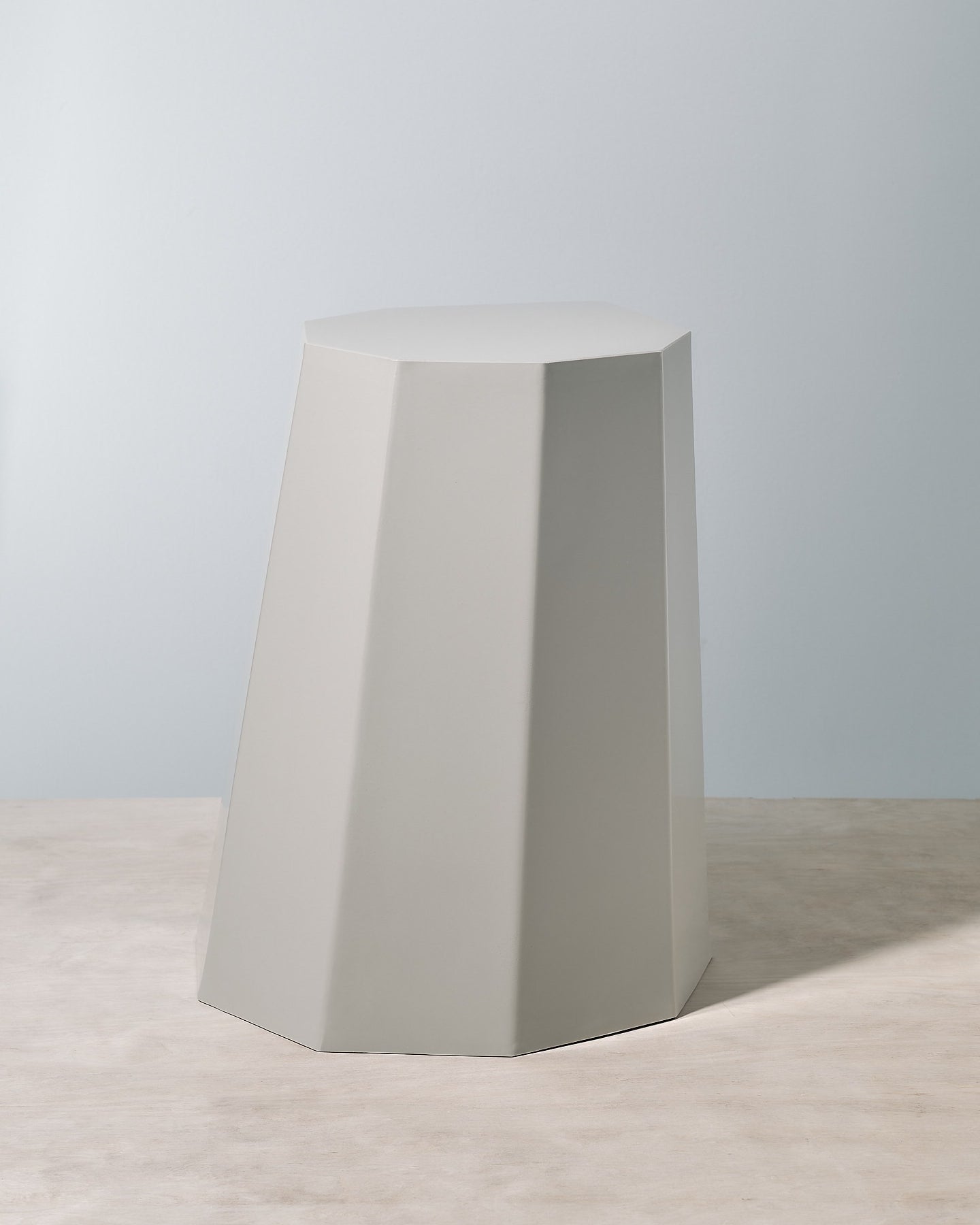 A grey Arnold Circus Stool – Cloud from the Martino Gamper brand with an octagonal shape.