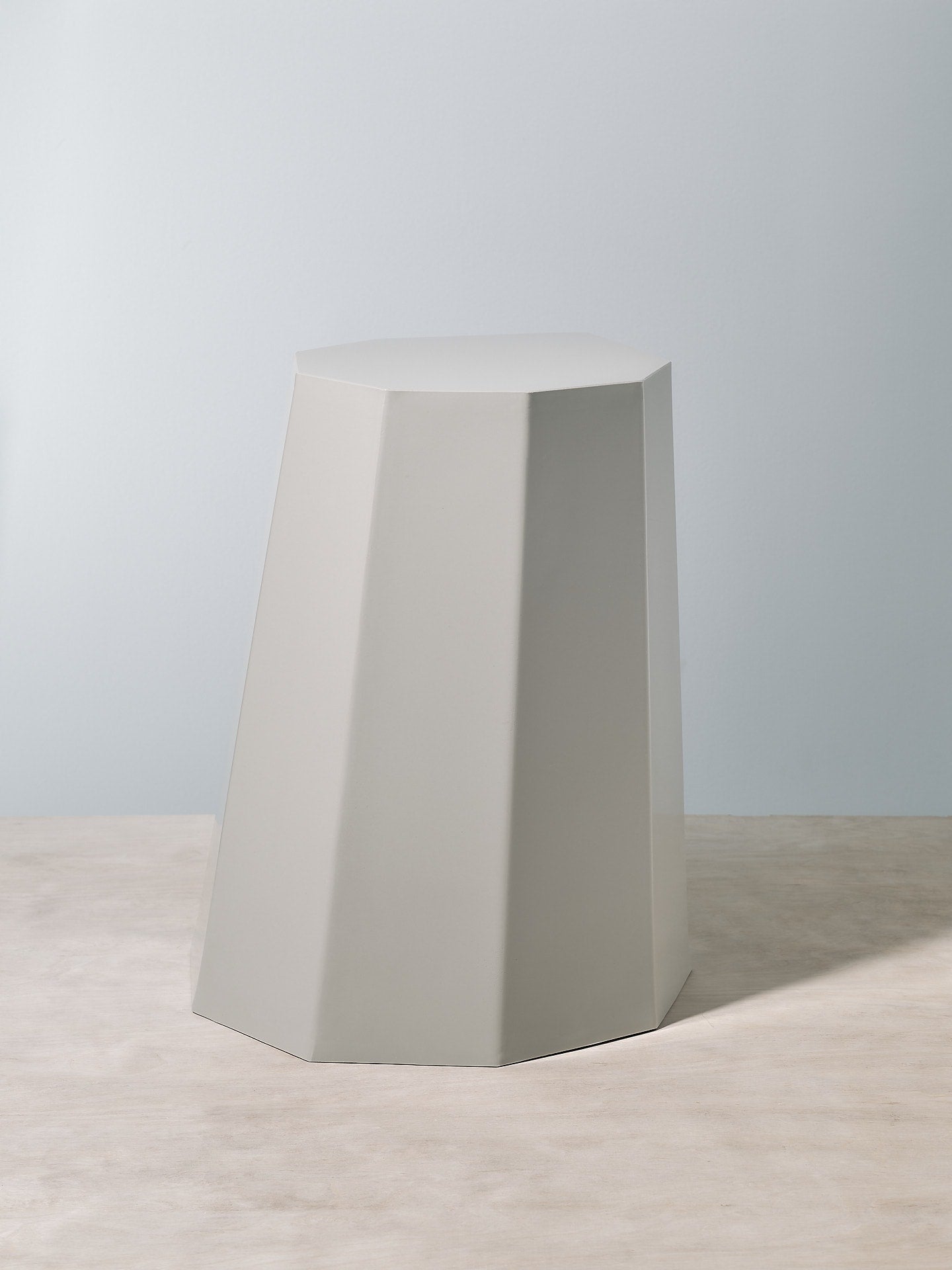 A grey Arnold Circus Stool – Cloud from the Martino Gamper brand with an octagonal shape.
