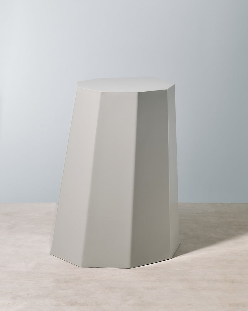 A grey Arnold Circus Stool – Cloud from the Martino Gamper brand with an octagonal shape.