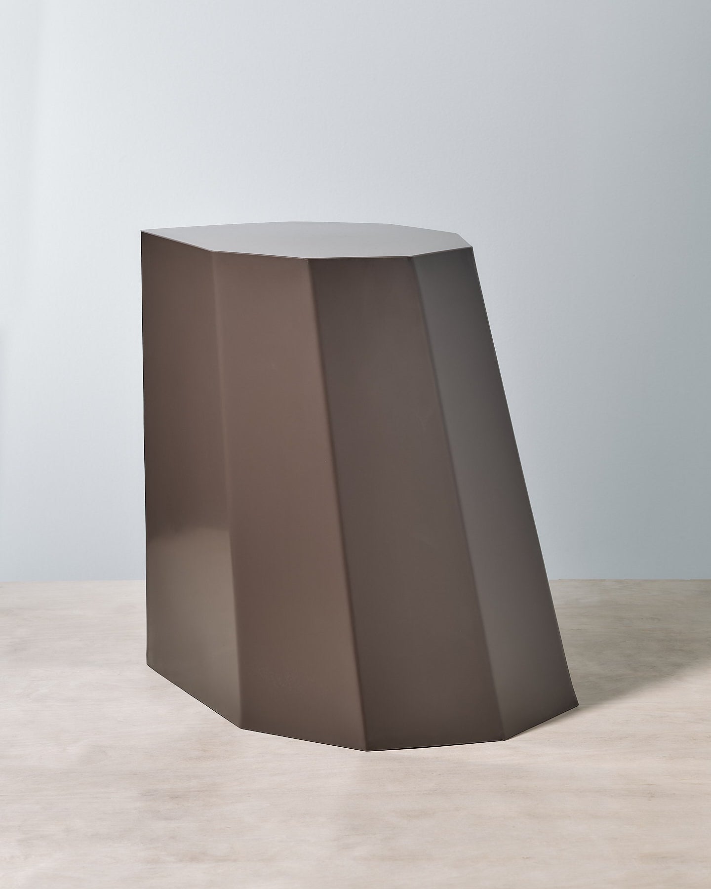 A Martino Gamper Arnold Circus Stool – Cocoa on a wooden surface.