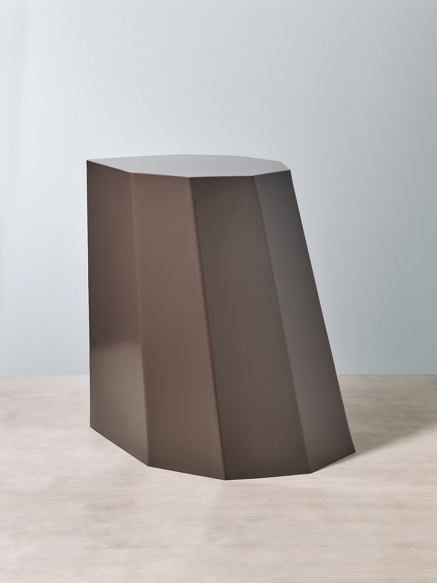 A Martino Gamper Arnold Circus Stool – Cocoa on a wooden surface.