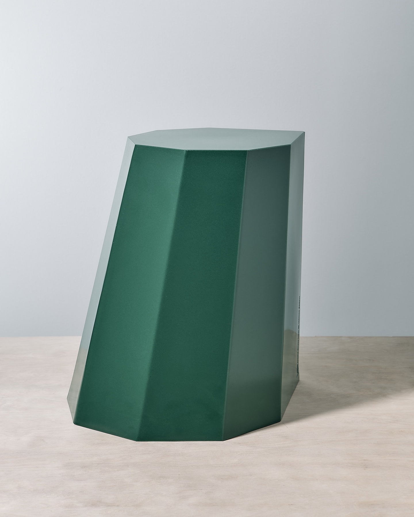 An Arnold Circus Stool - Forest by Martino Gamper on top of a white table.