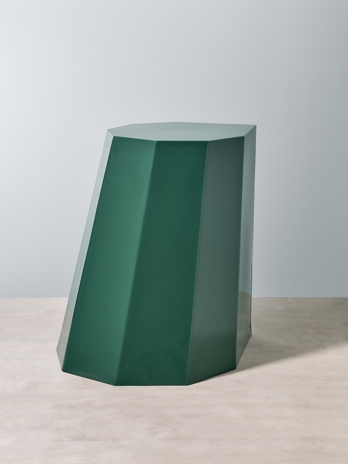 An Arnold Circus Stool - Forest by Martino Gamper on top of a white table.