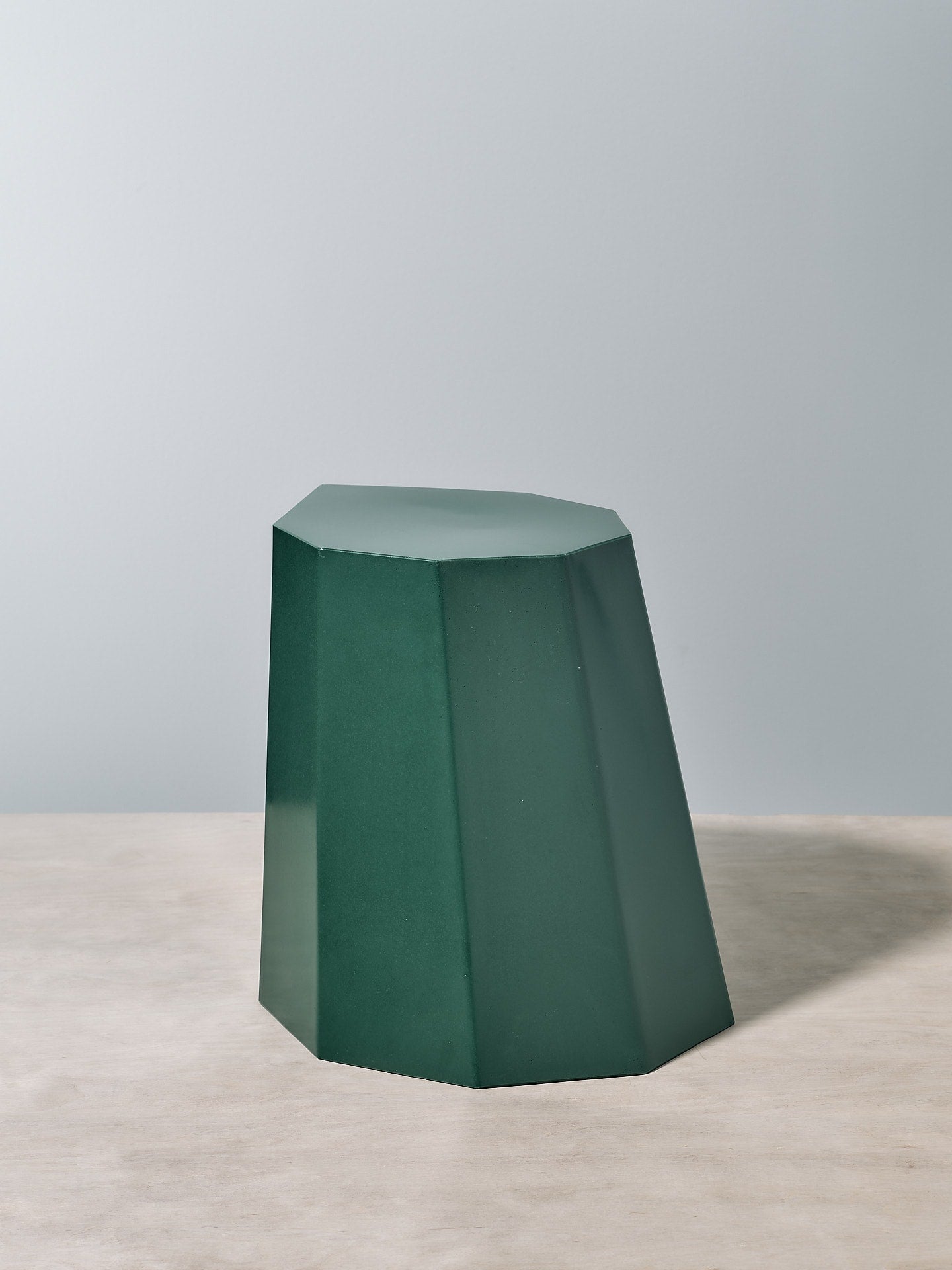 A Martino Gamper Arnoldino Stool – Forest sitting on top of a table.