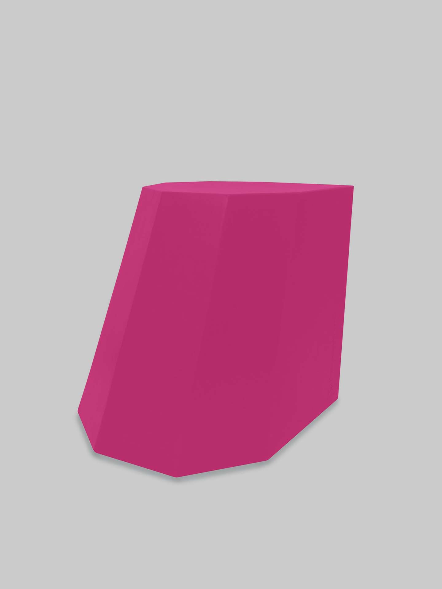 A magenta Arnoldino Stool by Martino Gamper, made from 100% recyclable polyethylene and featuring a slanted cuboid design, stands against a plain gray background.