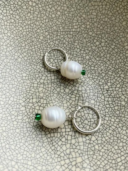 Avara Studio's Pearl Sleepers - Raindrop hoop earrings.