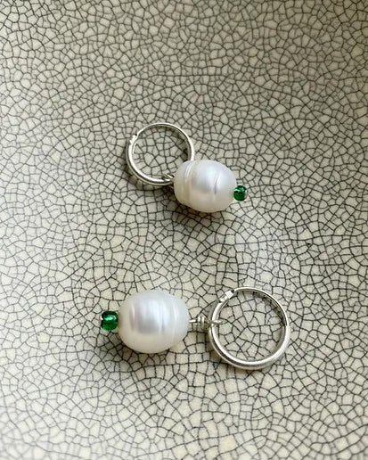 Avara Studio's Pearl Sleepers - Raindrop hoop earrings.