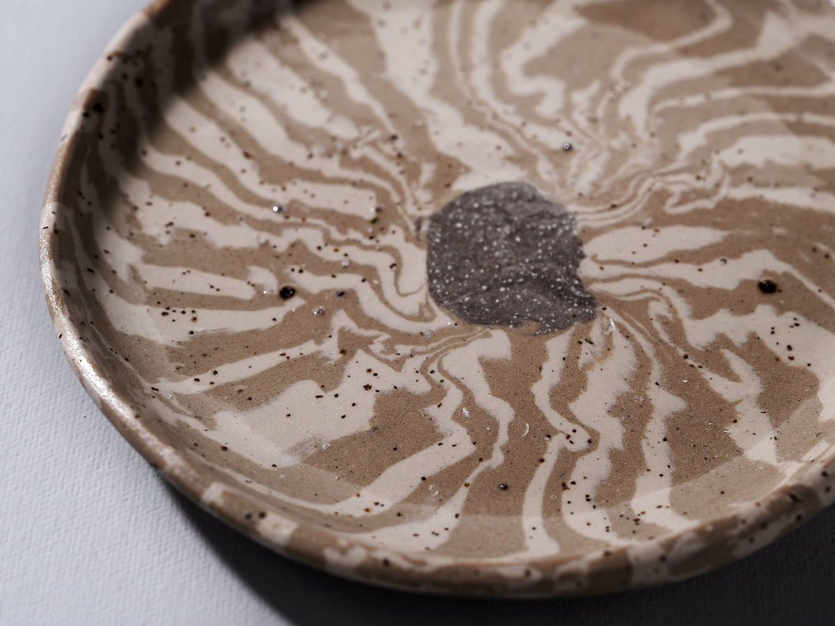 A Trinket Dish - Swirl from Avara Studio with a swirl design on it.