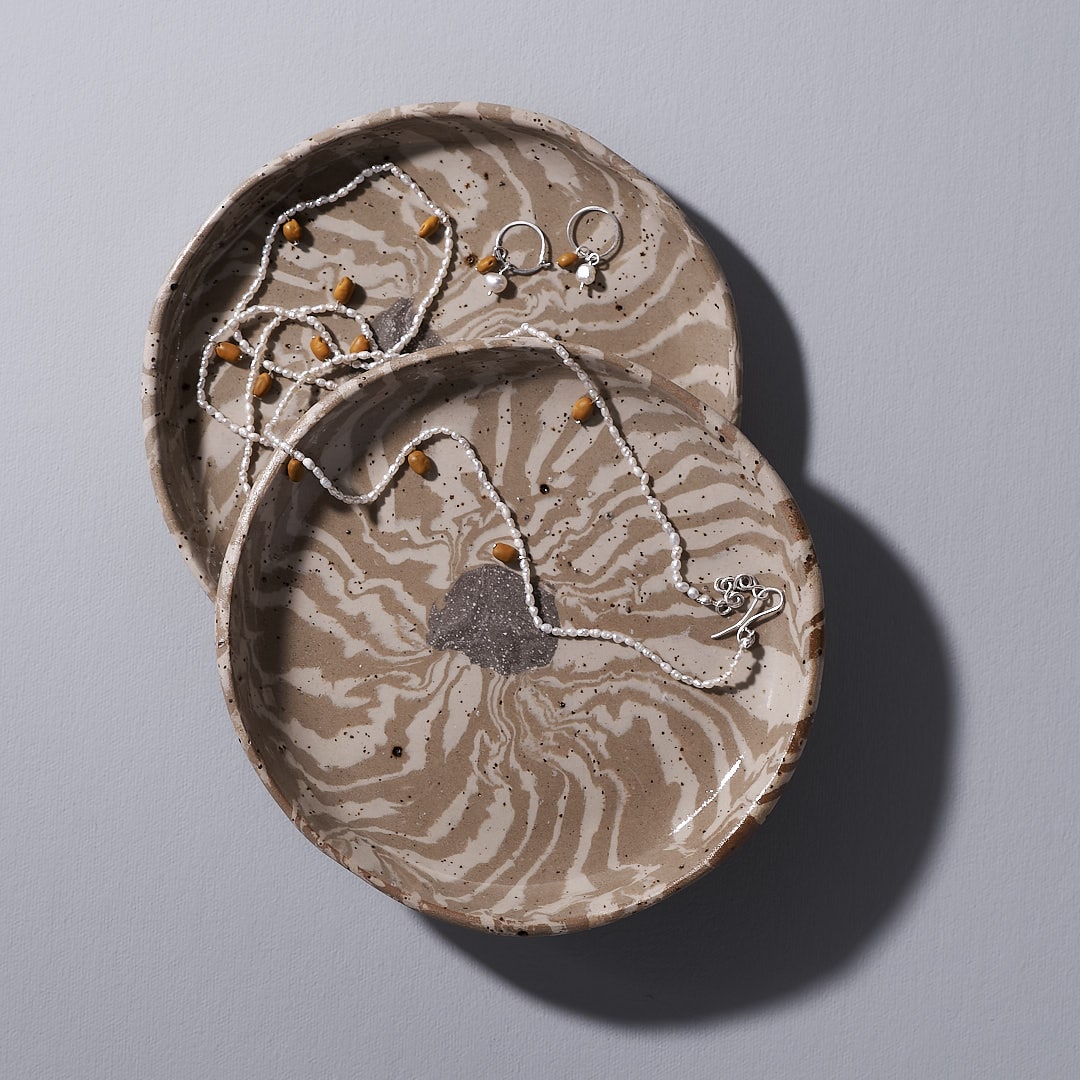 Two Trinket Dish - Swirls by Avara Studio with two necklaces on them.
