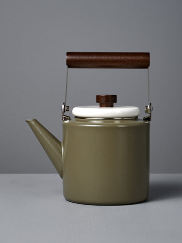 The Enamel Two-Tone Kettle – Olive Drab features a green finish, white lid, and dark walnut handle, displayed on a plain gray background.