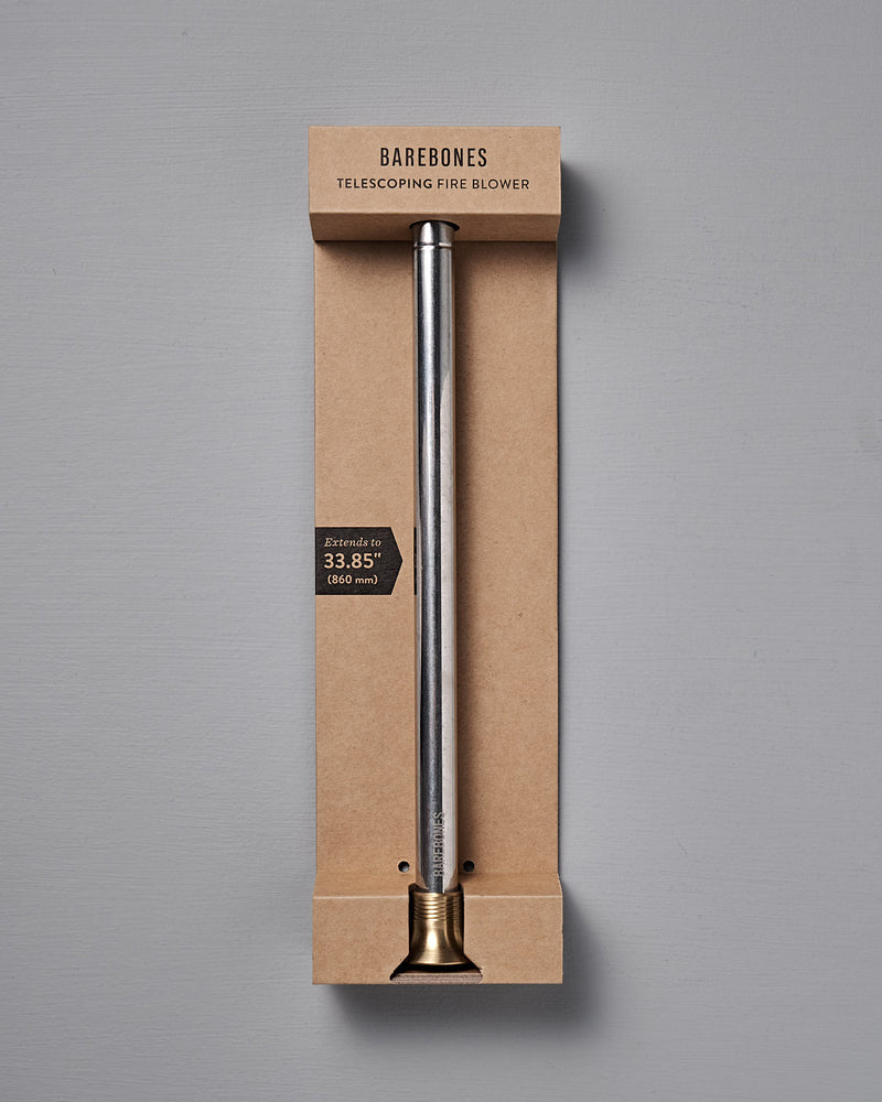 The Barebones Telescoping Fire Blower features a metal tube with brass tip, extends up to 33.85 inches, and is ideal for safely stoking campfires or fireplaces. Comes packaged and ready for outdoor use.