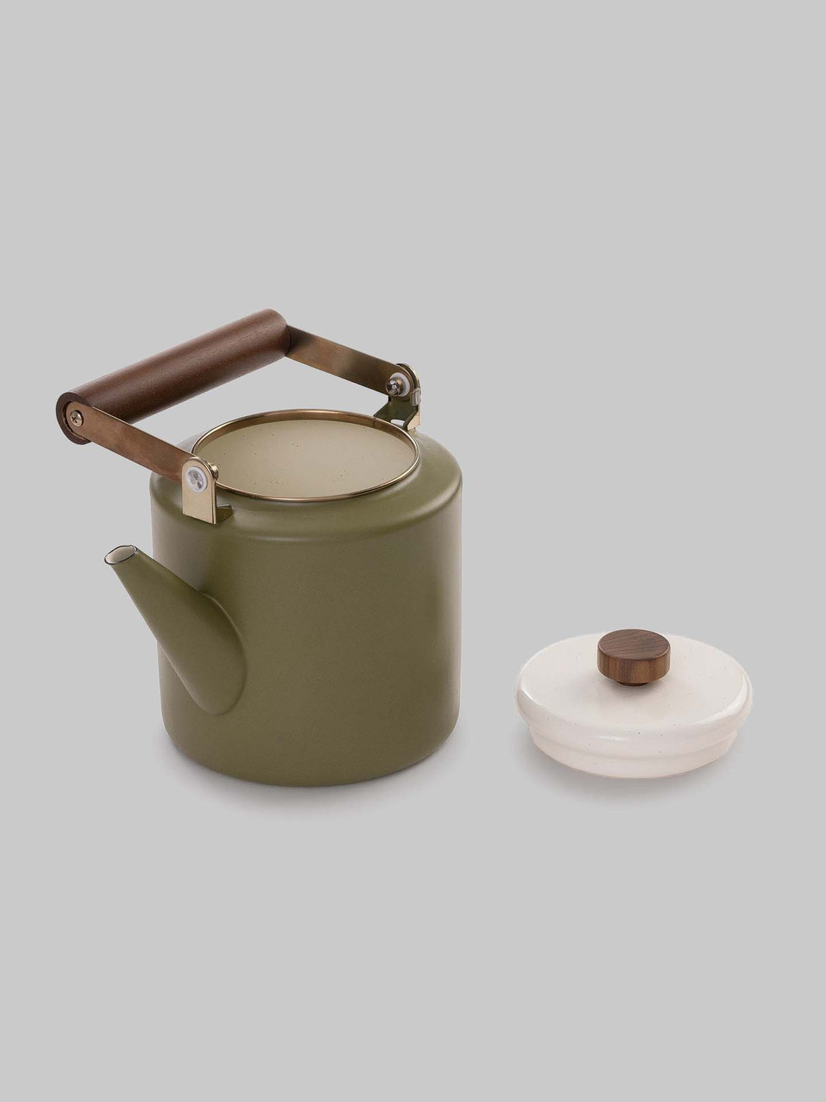 The Enamel Two-Tone Kettle in Olive Drab by Barebones is displayed without its lid, which is placed next to it against a plain grey backdrop. The lid is white with a brown knob, enhancing the kettle&#39;s vintage-inspired charm.