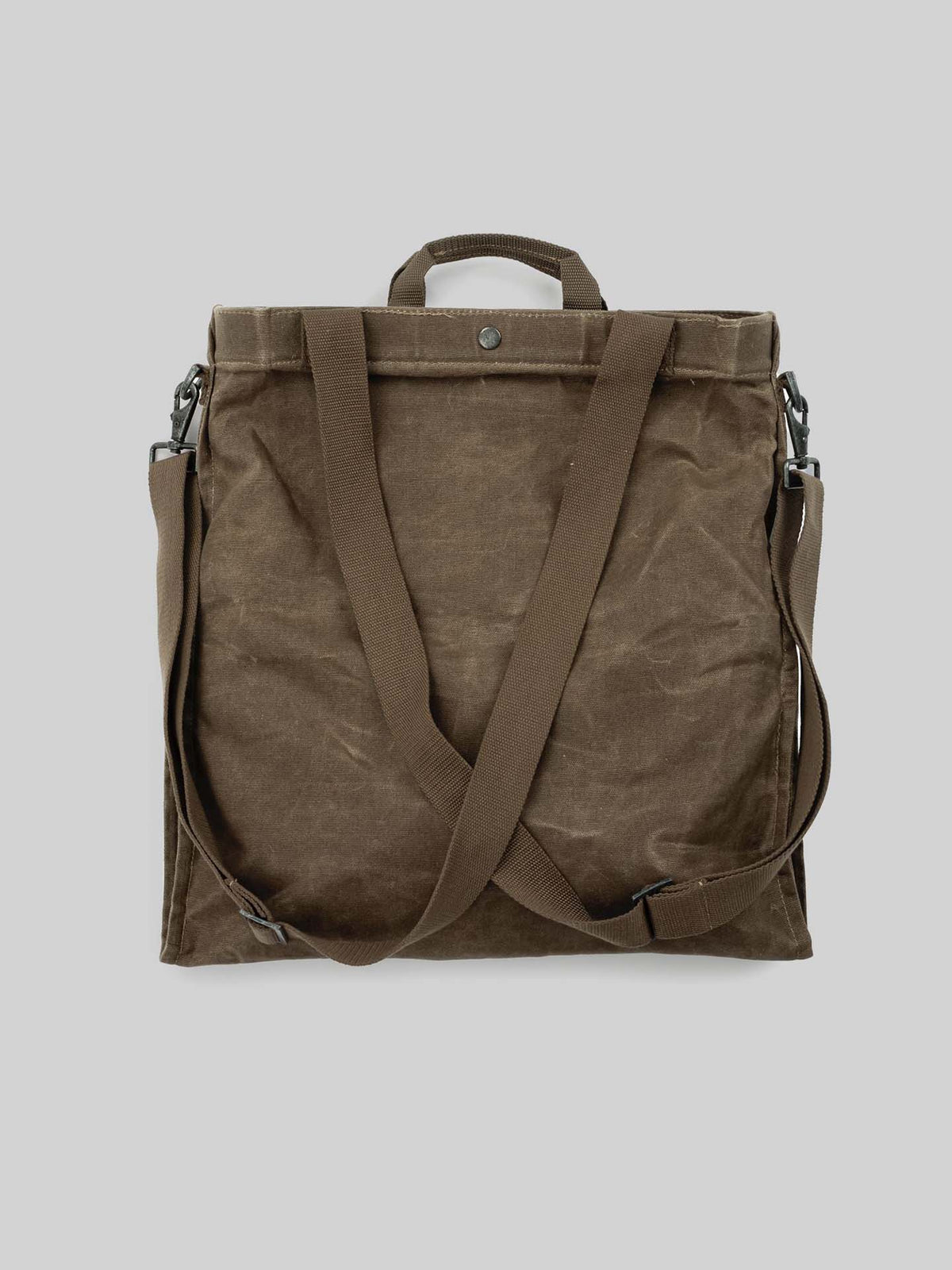 The Khaki Gathering Bag by Barebones, featuring two adjustable shoulder straps and a top handle, is showcased against a plain gray background.