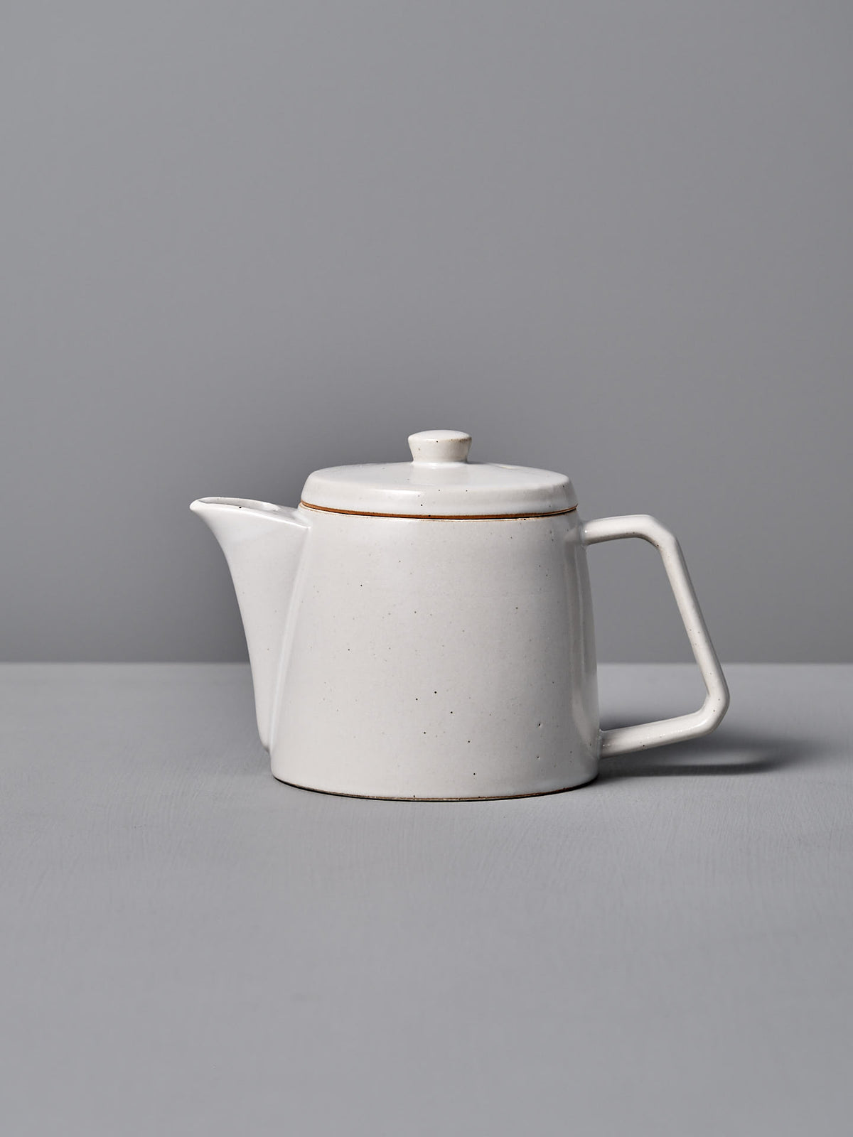 The CHIPS Inc. Mino-yaki Teapot (2 Cup) – White, with a square handle, is elegantly set against a gray background.