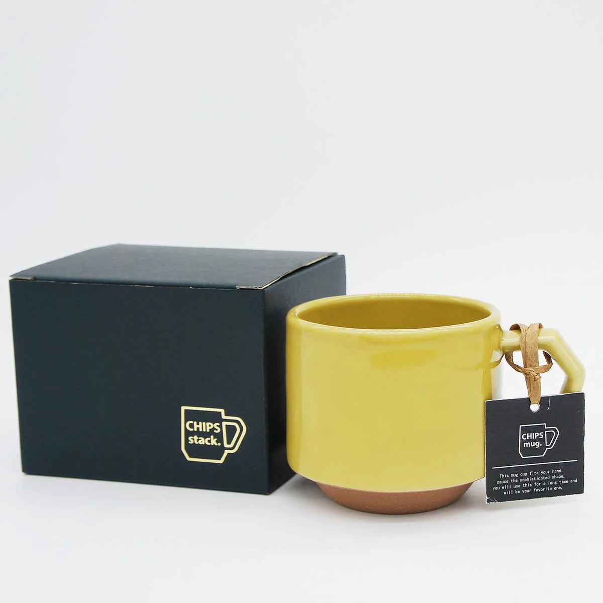 A Stacking Mug - Mustard from CHIPS Inc. with a black box and tag.