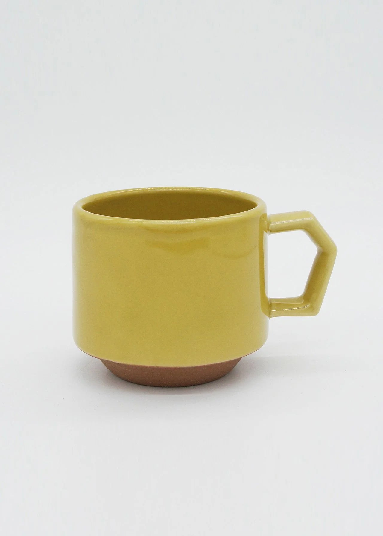 An artisan Stacking Mug – Mustard with a handle on a white background by CHIPS Inc.