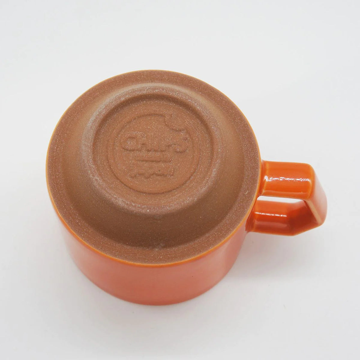 A Stacking Mug – Orange with a lid on it, offering both functionality and aesthetic appeal as a tableware. (Brand: CHIPS Inc.)